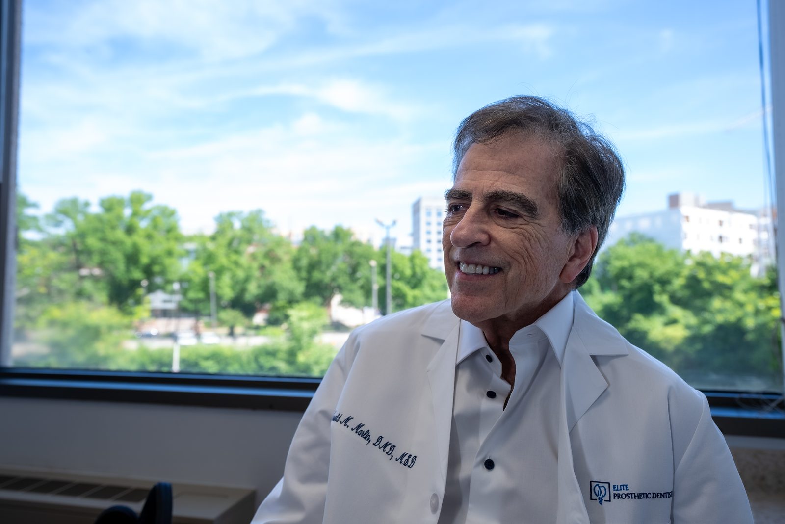 Dr. Marlin examining gum tissue health before dental implant placement for a patient near Bethesda